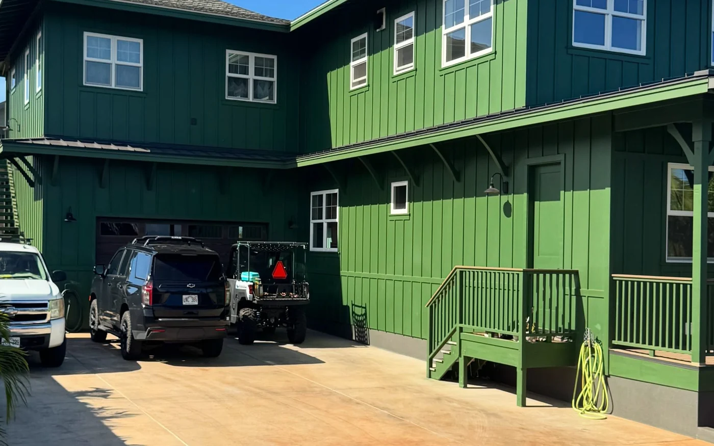Close view of the board and batten siding on the repainted Maui home, the coating even across the boards and the battens.